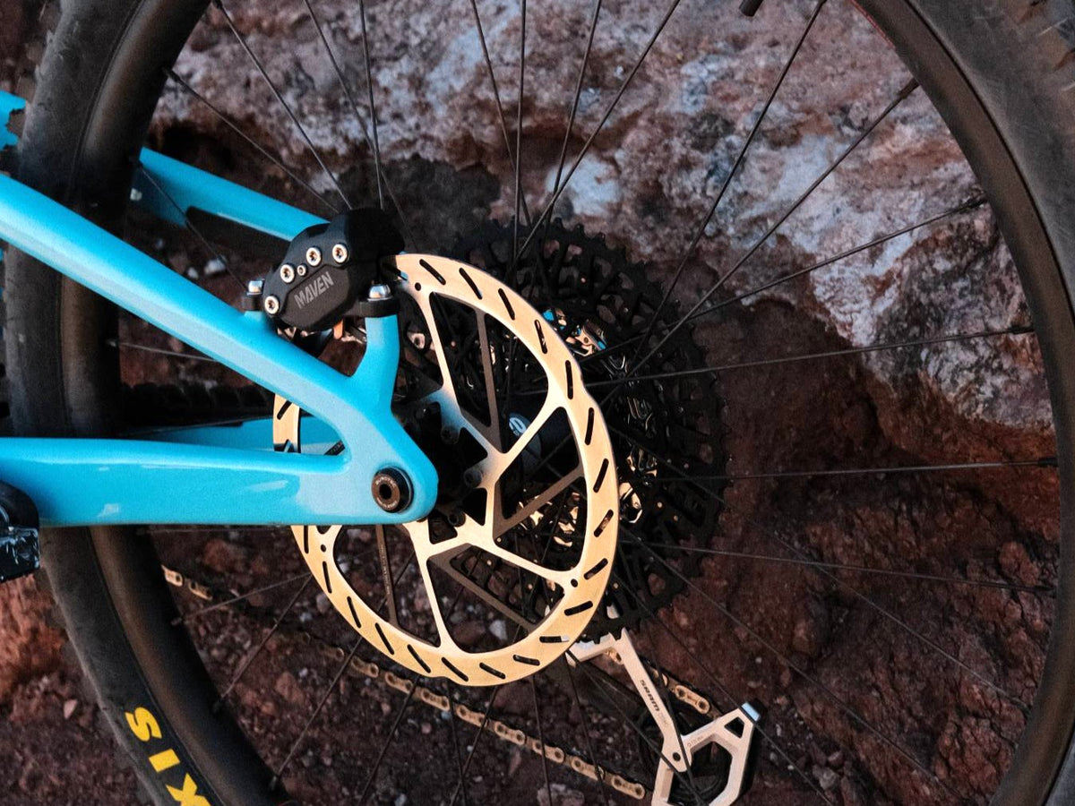 SRAM Maven brake caliper and rear rotor on a Gloss Aqua Magenta 2027 Santa Cruz Nomad