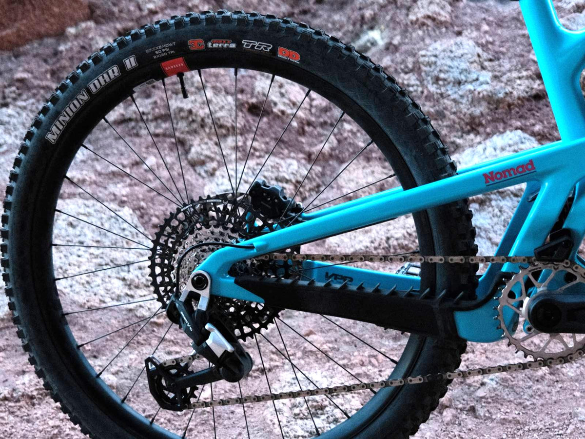 27.5-inch rear wheel and drivetrain on a Gloss Aqua Magenta 2027 Santa Cruz Nomad