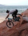 Rider on a very steep red rock descent on a 2027 Santa Cruz Nomad with desert valley views in Arizona