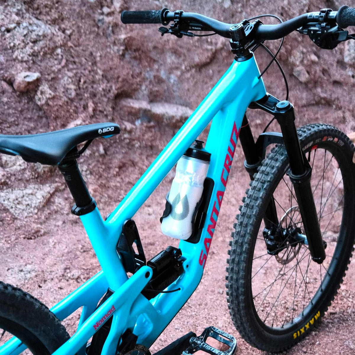 Water bottle in the front triangle of a Gloss Aqua Magenta 2027 Santa Cruz Nomad