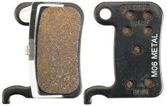 Pastillas de freno de disco Shimano M06-MX con resortes y compuesto metálico, placa trasera de acero (un par)